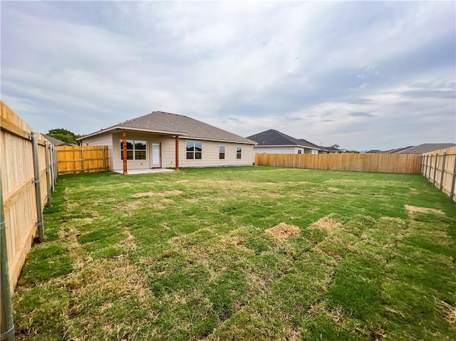 rear view of property featuring a lawn