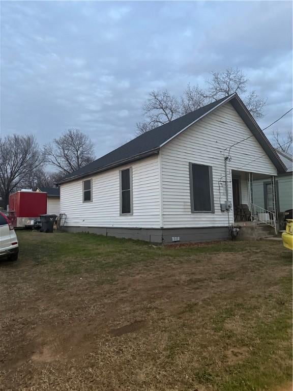 view of home's exterior with crawl space and a yard