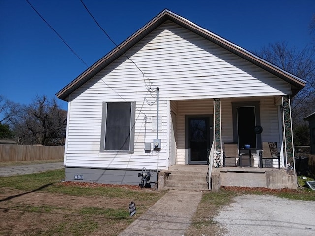 bungalow-style house featuring crawl space, fence, and a porch