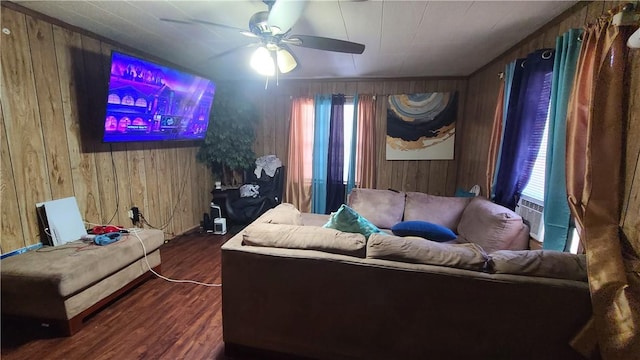 living room featuring ceiling fan, wooden walls, and wood finished floors