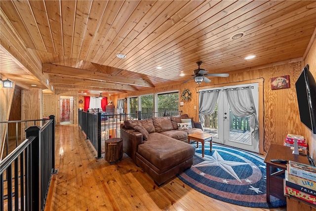 living room with hardwood / wood-style flooring, wooden ceiling, and wooden walls