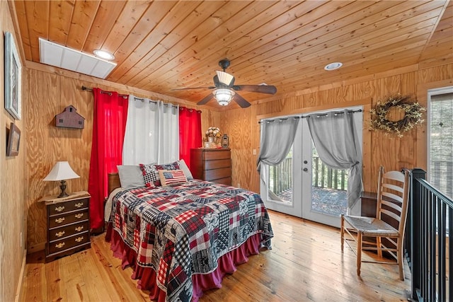 bedroom featuring access to exterior, hardwood / wood-style flooring, multiple windows, and ceiling fan