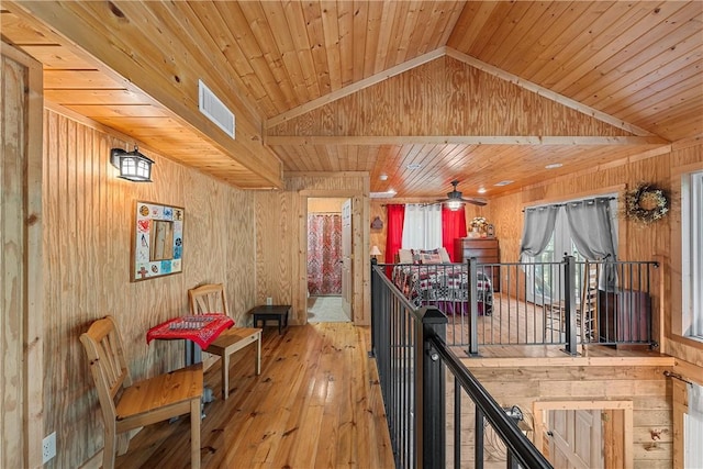 hallway featuring wood walls, wood ceiling, lofted ceiling, and wood-type flooring