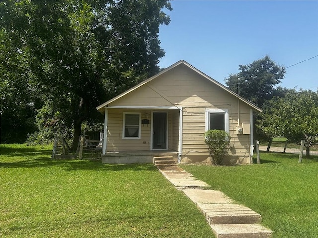 bungalow-style home featuring a porch and a front lawn