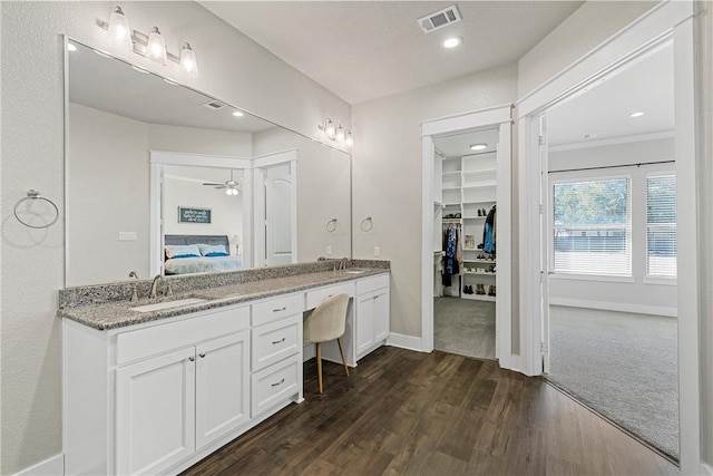 bathroom featuring hardwood / wood-style floors, ceiling fan, and vanity