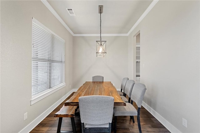 dining area with crown molding and dark wood-type flooring