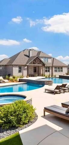 view of pool with a jacuzzi and a patio area