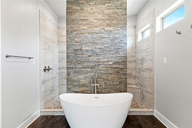 bathroom featuring wood-type flooring and a tub