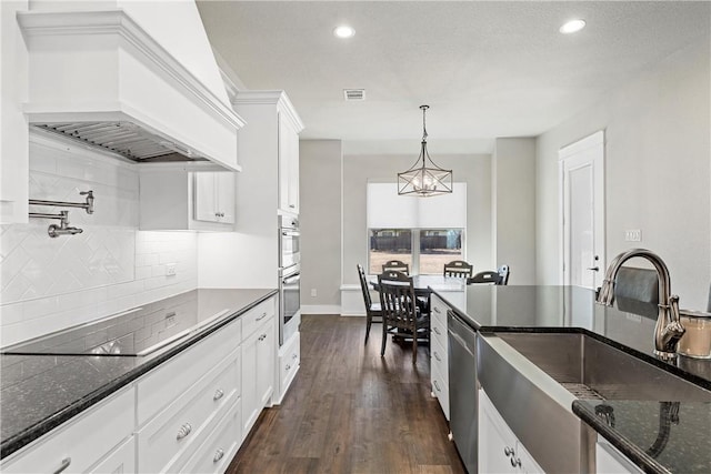 kitchen with pendant lighting, white cabinetry, premium range hood, and dark wood-type flooring