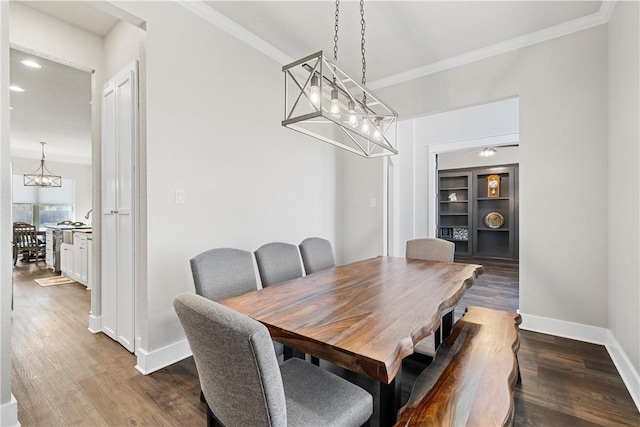 dining area with ornamental molding and dark wood-type flooring