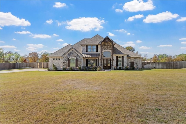 french country style house featuring a front yard