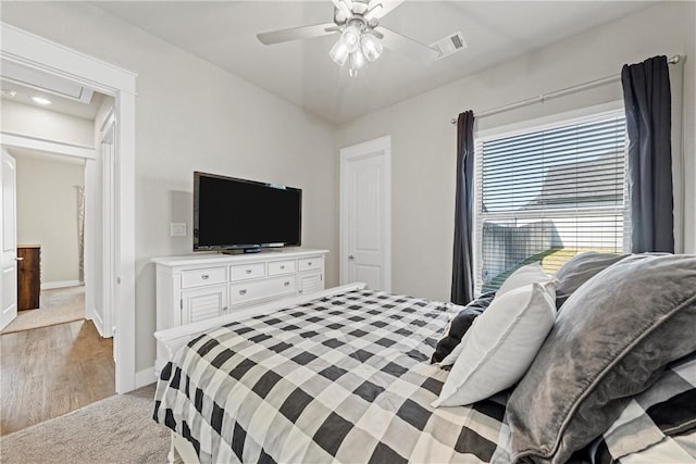 bedroom with light wood-type flooring and ceiling fan