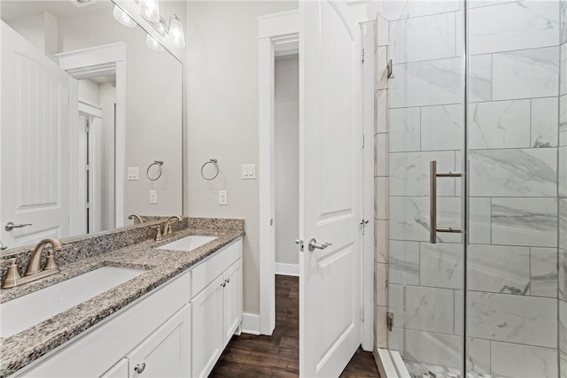 bathroom featuring hardwood / wood-style floors, vanity, and an enclosed shower