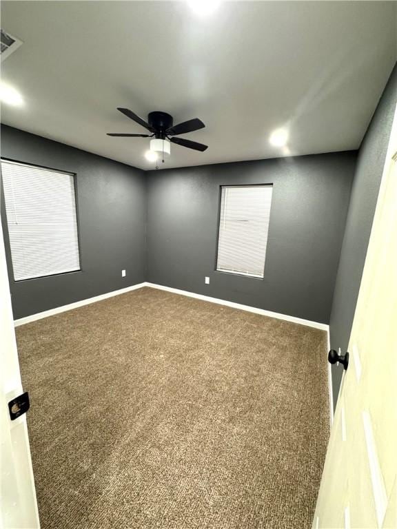 unfurnished room with carpet flooring and ceiling fan