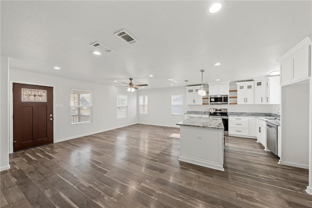 kitchen with a center island, hanging light fixtures, white cabinets, appliances with stainless steel finishes, and ceiling fan