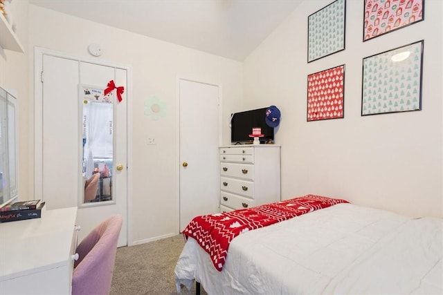 bedroom featuring vaulted ceiling and light carpet