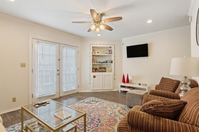 living room featuring french doors, ornamental molding, wood-type flooring, and ceiling fan