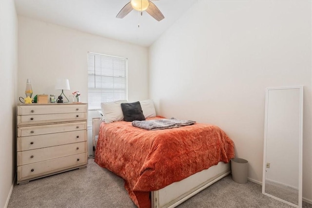 bedroom with vaulted ceiling, light colored carpet, and ceiling fan