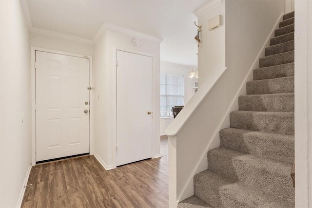 foyer with hardwood / wood-style flooring and ornamental molding