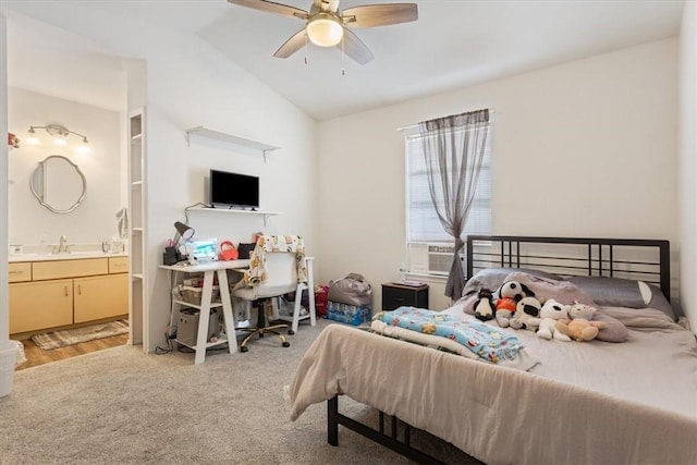 carpeted bedroom with vaulted ceiling, sink, cooling unit, ceiling fan, and ensuite bath