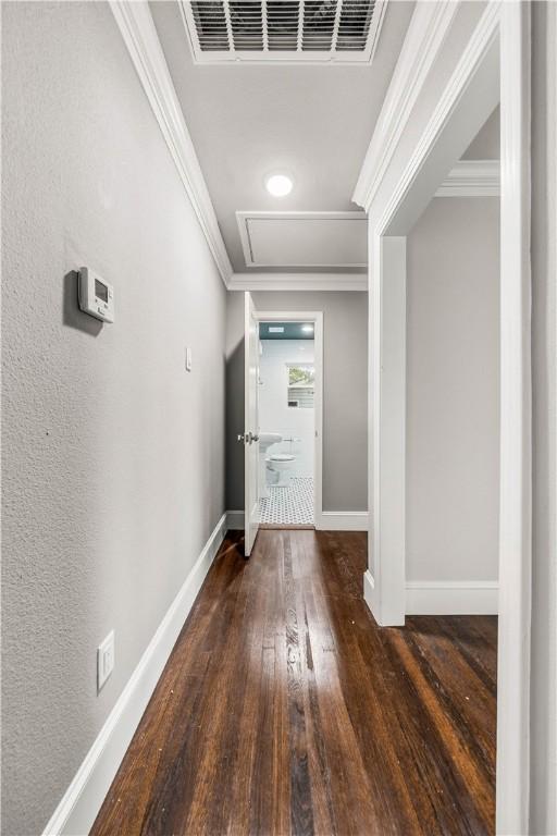 hallway featuring dark hardwood / wood-style flooring and ornamental molding