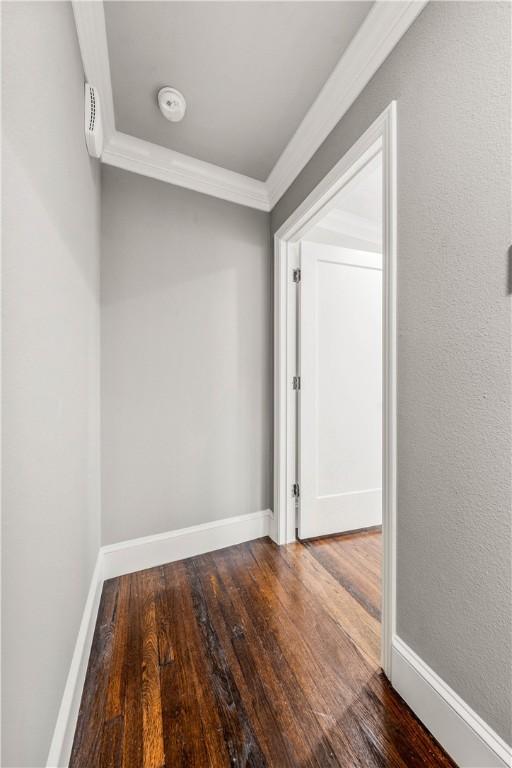 interior space with wood-type flooring and ornamental molding