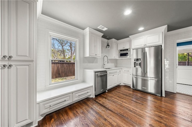 kitchen with dark hardwood / wood-style flooring, white cabinets, stainless steel appliances, and sink