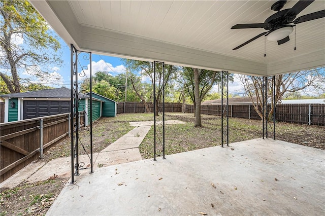 view of patio / terrace featuring ceiling fan and an outbuilding