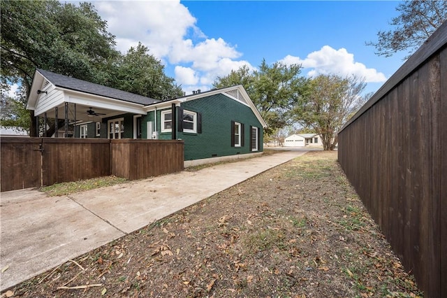 view of side of home with ceiling fan