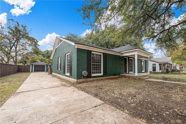 view of front of house with a porch, a garage, and an outdoor structure