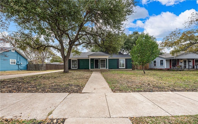 ranch-style home featuring a front yard