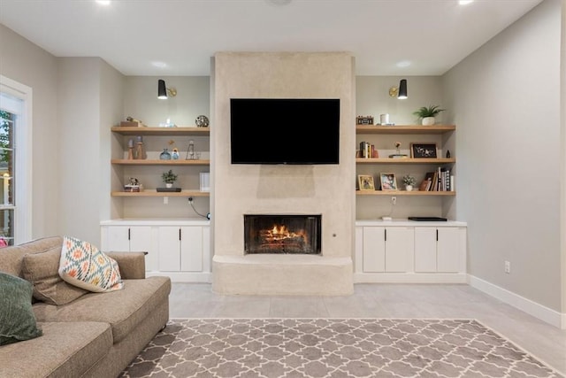 living room featuring a large fireplace