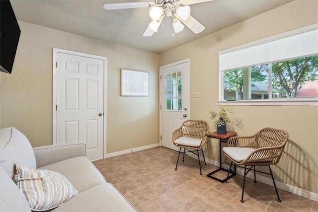 living area with ceiling fan