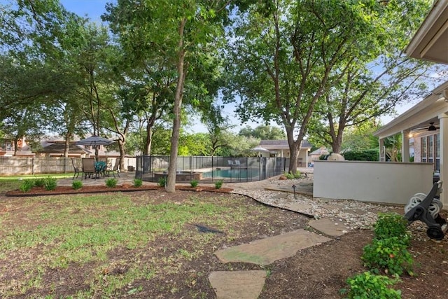 view of yard featuring a fenced in pool and a patio