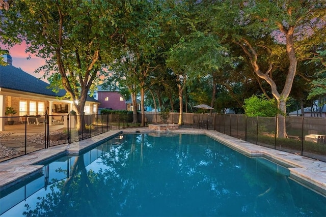 view of pool at dusk