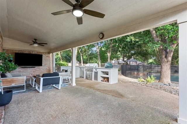 view of patio / terrace featuring a grill, ceiling fan, and exterior kitchen