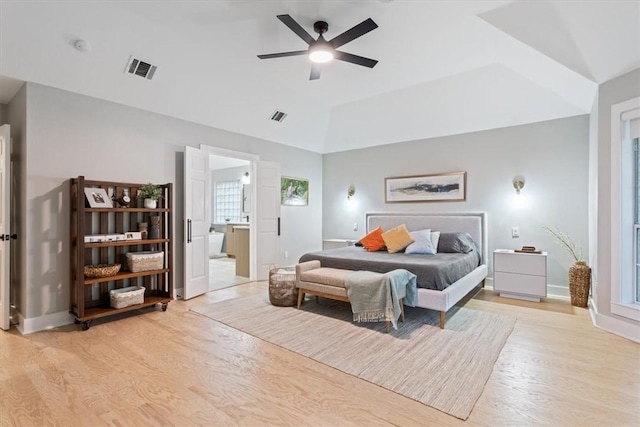 bedroom with connected bathroom, ceiling fan, light hardwood / wood-style flooring, and lofted ceiling