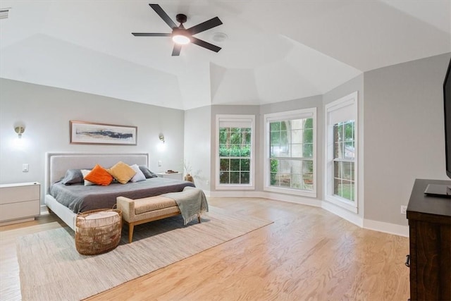 bedroom featuring ceiling fan, vaulted ceiling, and light hardwood / wood-style flooring