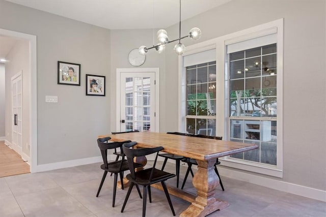 dining room with tile patterned flooring and an inviting chandelier