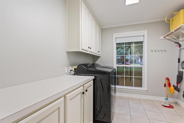 laundry room featuring cabinets, independent washer and dryer, and light tile patterned floors