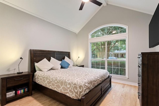 bedroom with light wood-type flooring, lofted ceiling with beams, ceiling fan, and crown molding