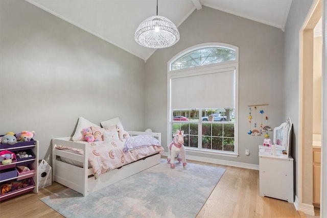 bedroom featuring lofted ceiling with beams, a chandelier, and light hardwood / wood-style floors