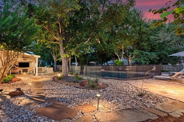 yard at dusk with a patio