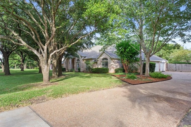 view of front of home featuring a garage and a front lawn