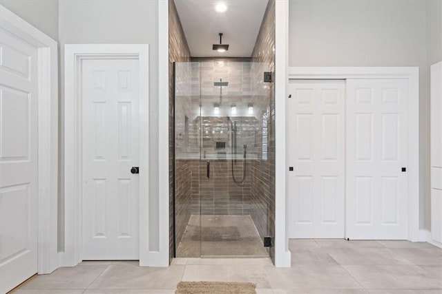 bathroom with tile patterned floors and an enclosed shower