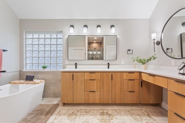 bathroom with vanity, tile walls, and independent shower and bath