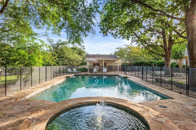 view of swimming pool featuring an in ground hot tub