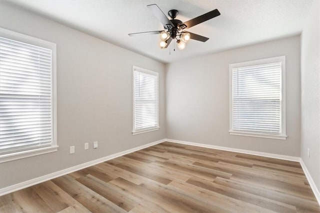 empty room with ceiling fan and light wood-type flooring