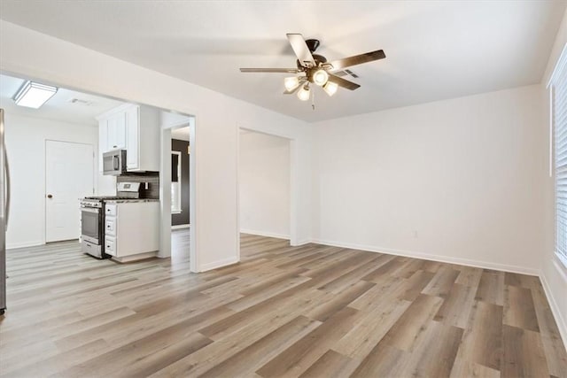 unfurnished living room featuring light wood-type flooring and ceiling fan