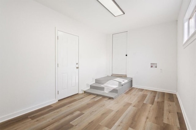 interior space featuring hookup for a washing machine and light hardwood / wood-style floors